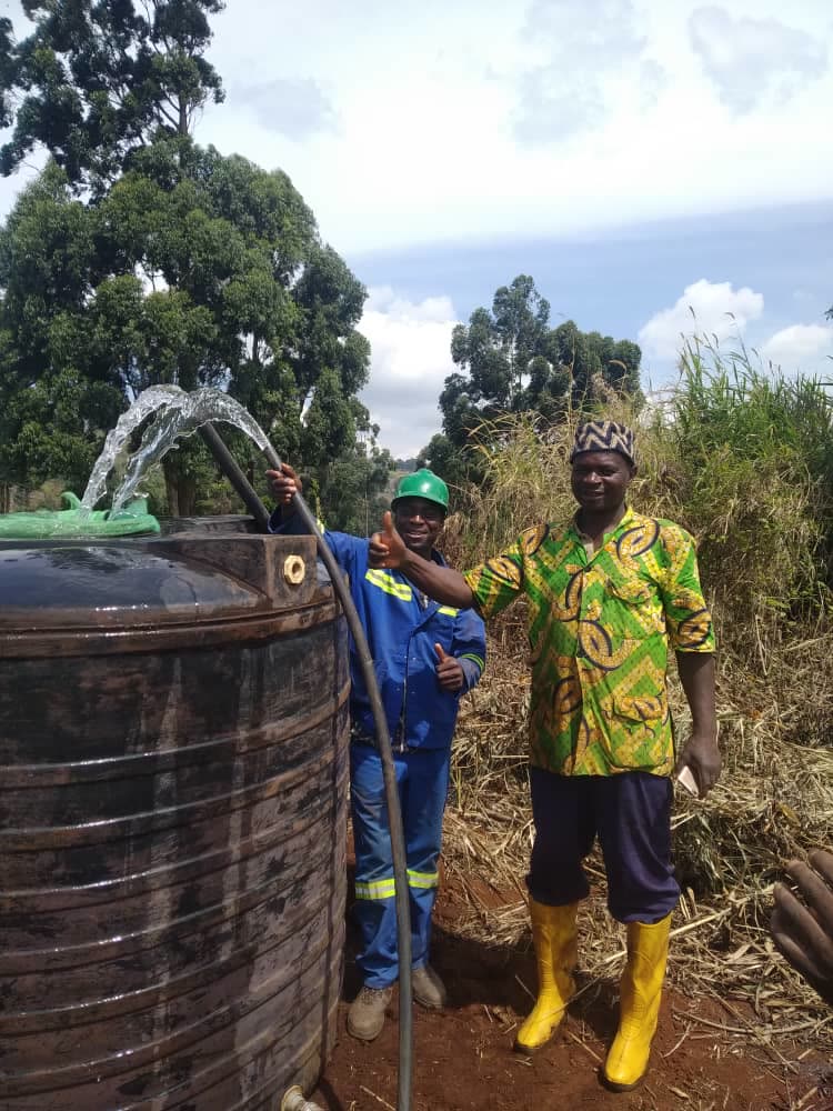 Solar pumping: borehole water fills a tank, with a technician and the farmer