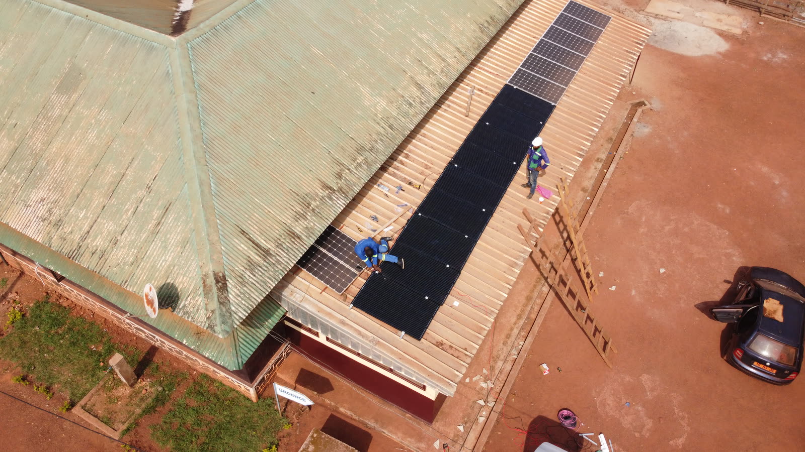 Aerial view of a crew installing panels on a hospital roof