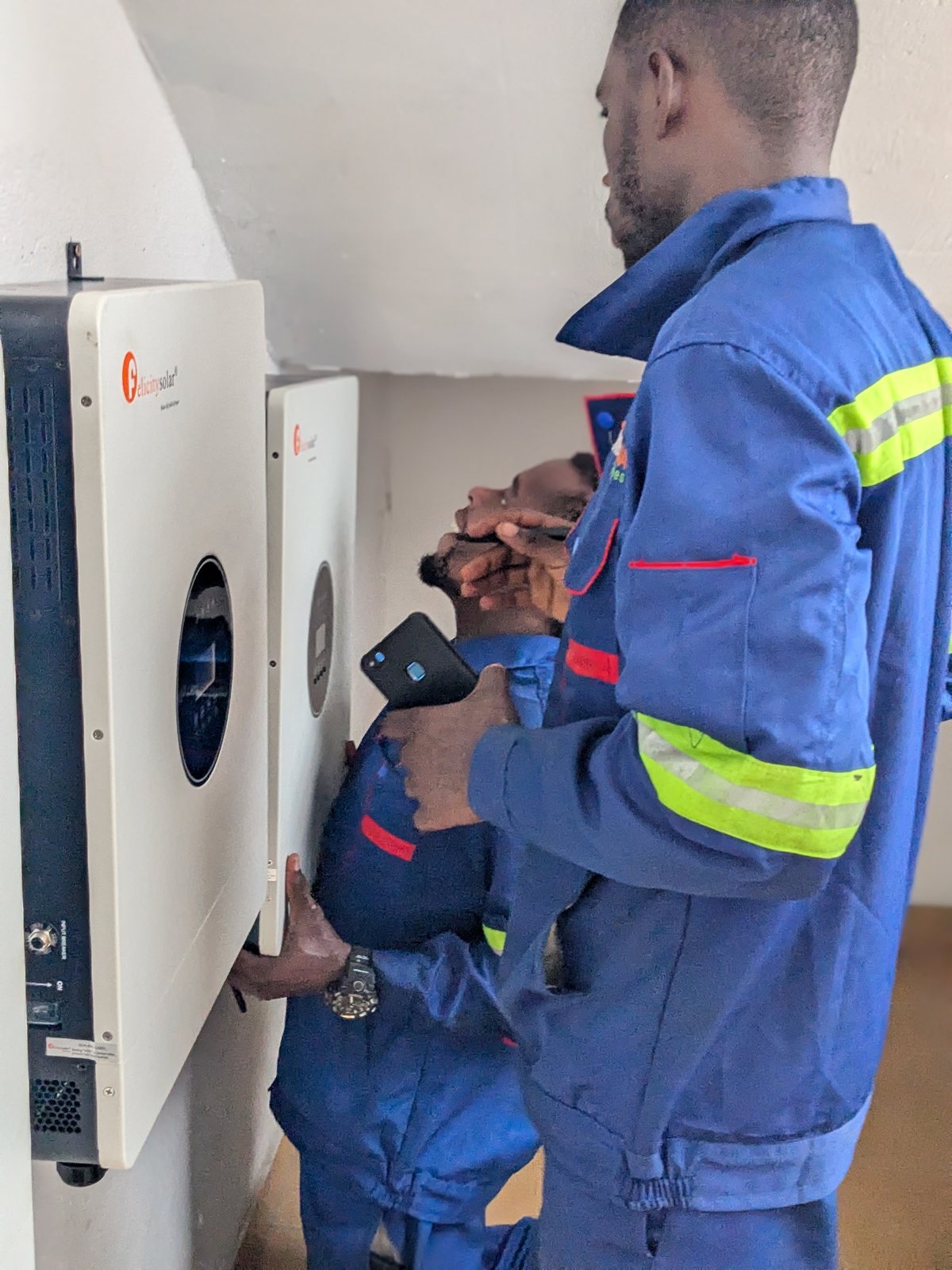 Technicians connecting a remotely monitored hybrid inverter, STIHL Douala