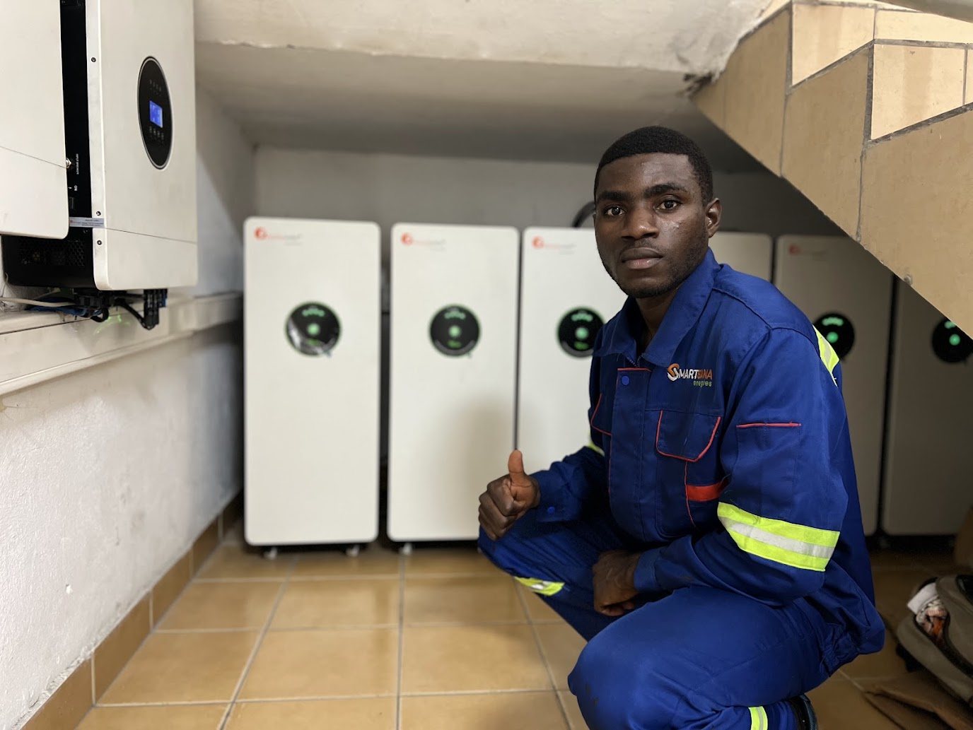 SmartSana technician in front of the STIHL inverters and lithium batteries, Douala