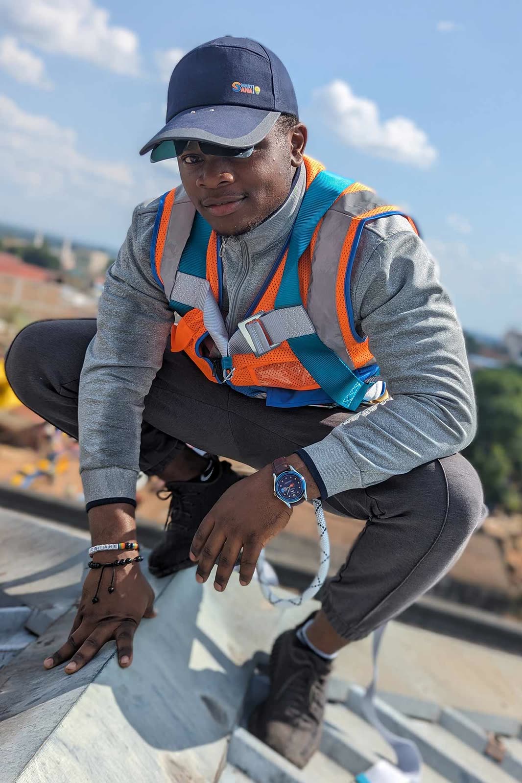 SmartSana technician in a safety harness on a roof