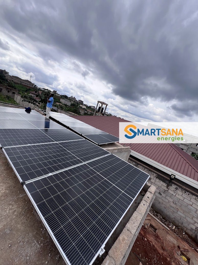 Technician on the roof during panel mounting, Nkolfoulou